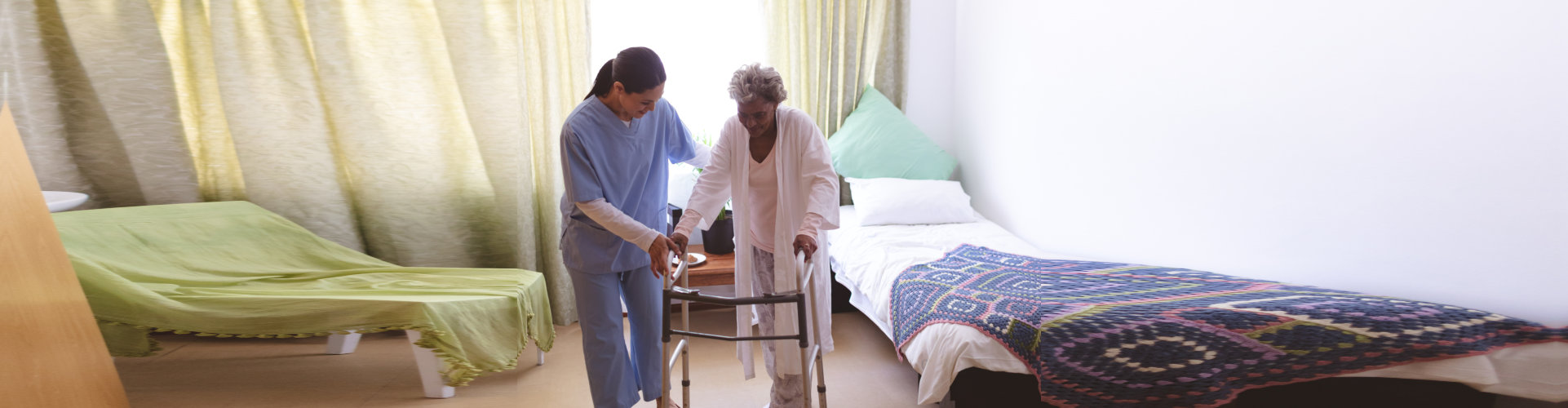 caregiver assisting senior woman walk